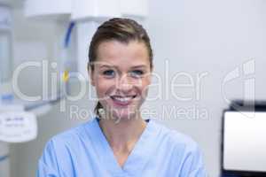 Portrait of dental assistant standing in dental clinic