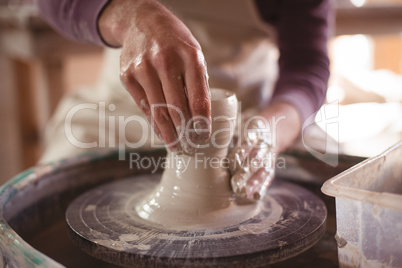 Male potter making pot