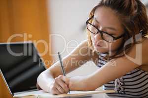 Young woman studying in classroom