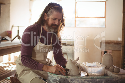 Male potter making pot