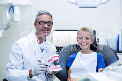 Portrait of smiling dentist and young patient