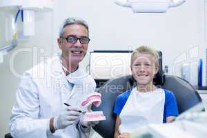 Portrait of smiling dentist and young patient