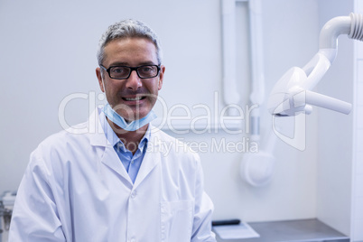 Portrait of a dentist adjusting light