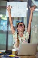 Excited graphic designer sitting with laptop