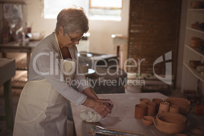 Female potter molding clay