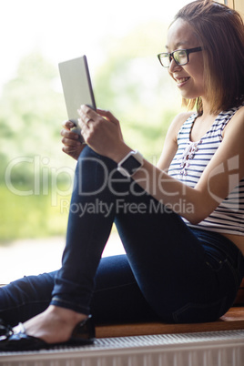 Young woman using digital tablet