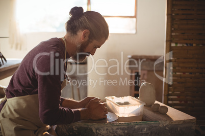 Male potter making pot