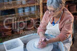 Female potter making pot