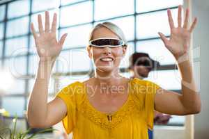 Female business executive using virtual reality video glasses