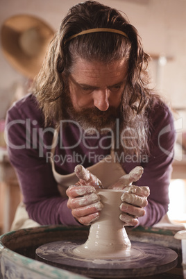 Male potter making pot