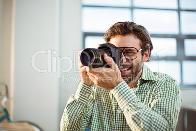 Graphic designer clicking photo from digital camera