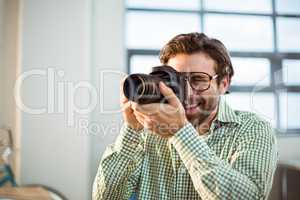 Graphic designer clicking photo from digital camera