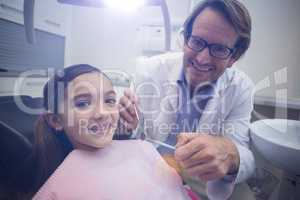 Portrait of smiling dentist and young patient