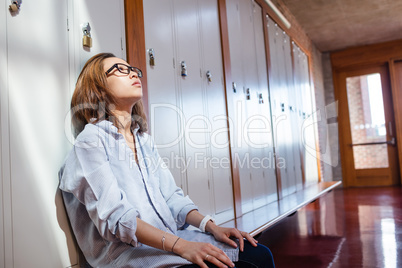 Tensed woman sitting in locker room