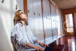 Tensed woman sitting in locker room