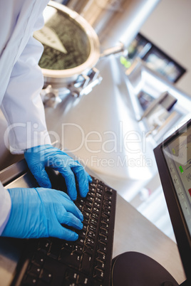 Manufacturer hand working on computer at brewery