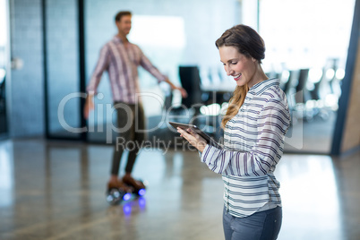 Smiling woman using digital tablet