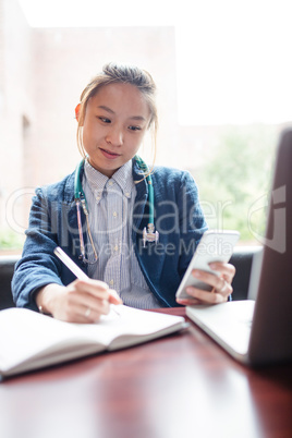 Female doctor using mobile phone