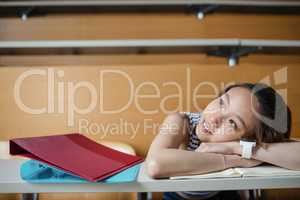 Thoughtful young woman leaning on bench