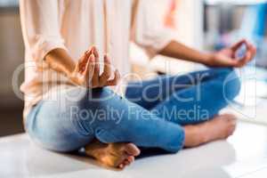 Business executive performing yoga