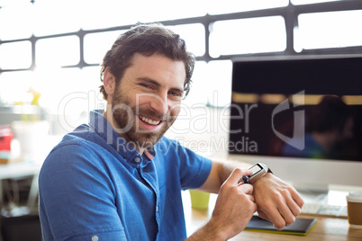 Business executive adjusting a smartwatch