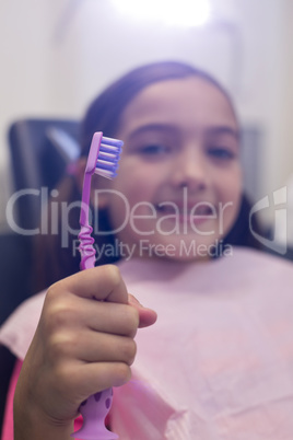 Young patient holding her toothbrush