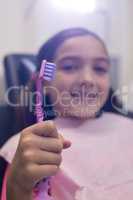 Young patient holding her toothbrush