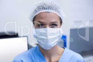 Dental assistant wearing surgical mask in dental clinic