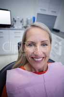 Female patient sitting on dentist chair