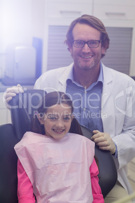 Portrait of smiling dentist and young patient