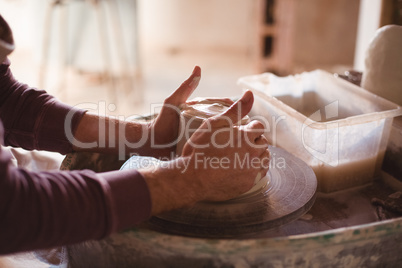 Male potter making pot