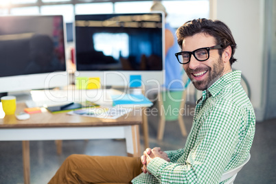 Graphic designer sitting on chair in office