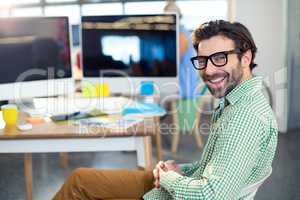 Graphic designer sitting on chair in office