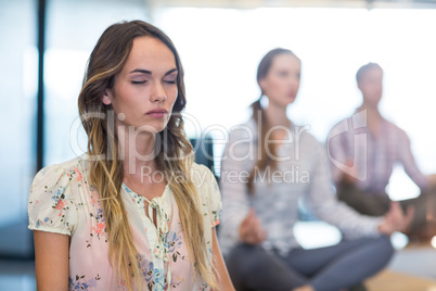 Business people performing yoga