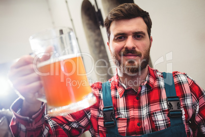 Portrait of manufacturer holding beer jug