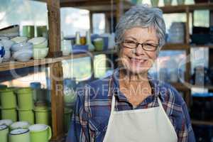 Female potter standing in pottery workshop