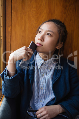 Thoughtful woman looking through window