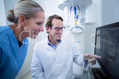 Dentist and dental assistant discussing a x-ray on the monitor