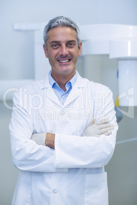 Portrait of dentist standing with arms crossed