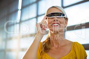 Female business executive using virtual reality video glasses