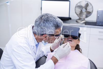 Dentist examine female patient with dental tools