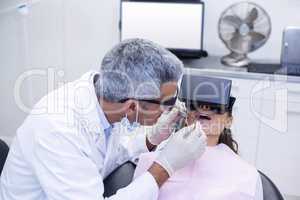 Dentist examine female patient with dental tools