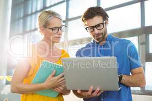 Business executives discussion over laptop