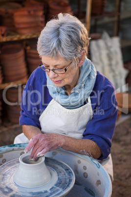 Female potter making pot