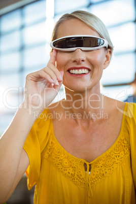 Female business executive using virtual reality video glasses