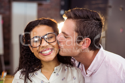 Man kissing woman on cheek