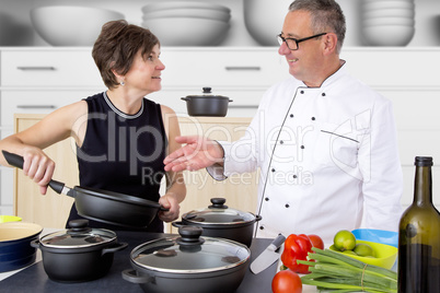 Elegant woman with Chef Cook in the kitchen