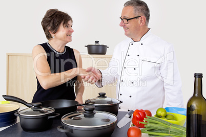 Elegant woman with Chef Cook in the kitchen