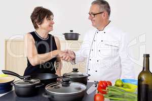 Elegant woman with Chef Cook in the kitchen
