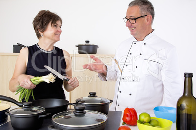 Elegant woman with Chef Cook in the kitchen